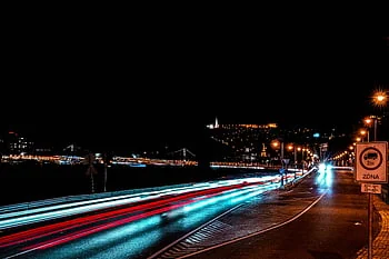 Night cityscape with light trails — the city that never fully wakes