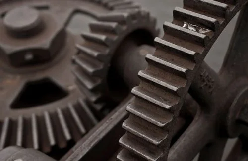 Interlocking metal gears — the mechanism of bureaucracy