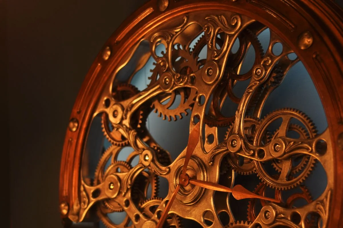 Exposed mechanical clock movement, gears and springs in brass, precision and complexity visible