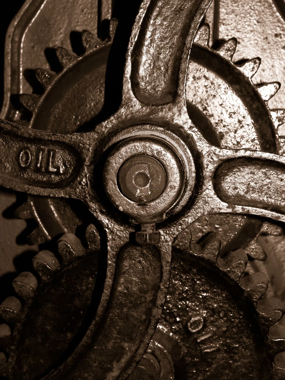 Close-up of worn brass gears, one with a visible shine from years of hand contact