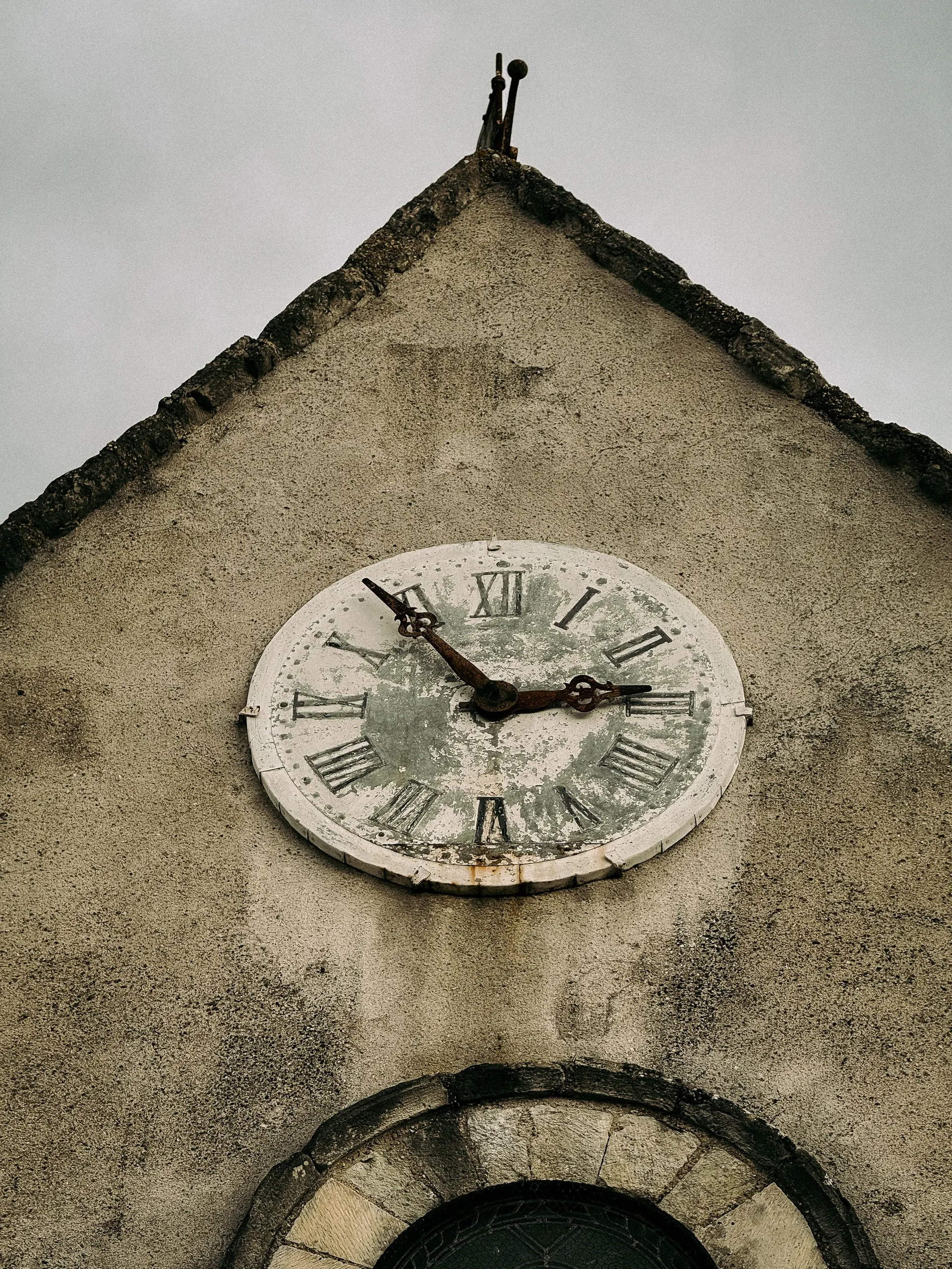 An old clock tower against a soft evening sky, warm light glowing from the clock face — one hundred and seventy years of the same motion, the same telling of time