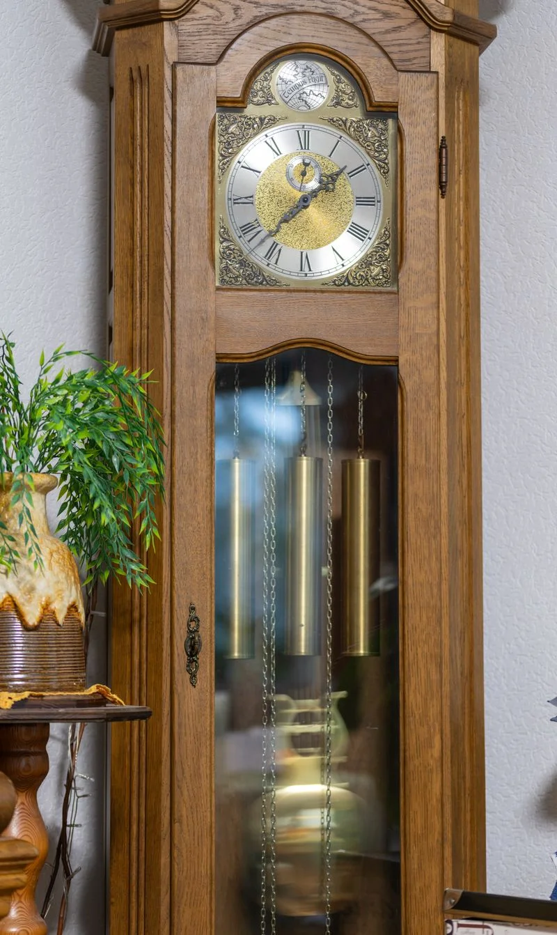 Ornate grandfather clock with visible pendulum