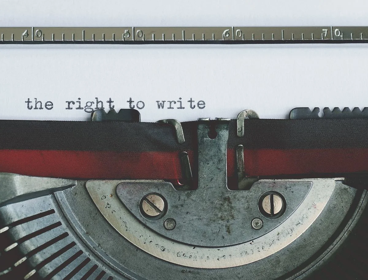 Close-up of an old mechanical typewriter with paper loaded, keys worn smooth with use
