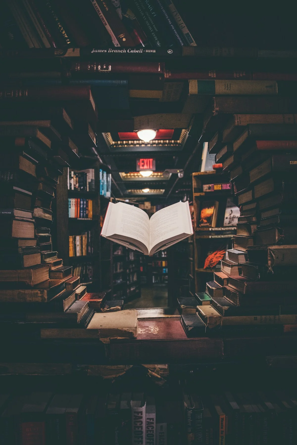 Stack of old weathered books with worn leather spines and foxed pages