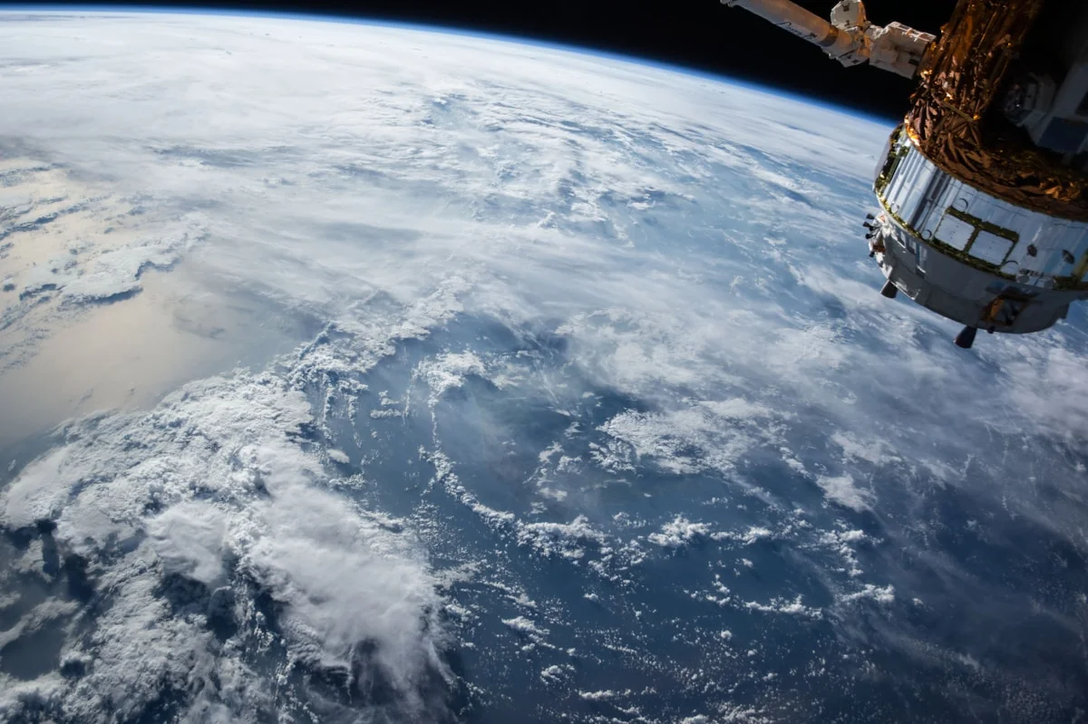An astronaut figure standing alone against a dark landscape
