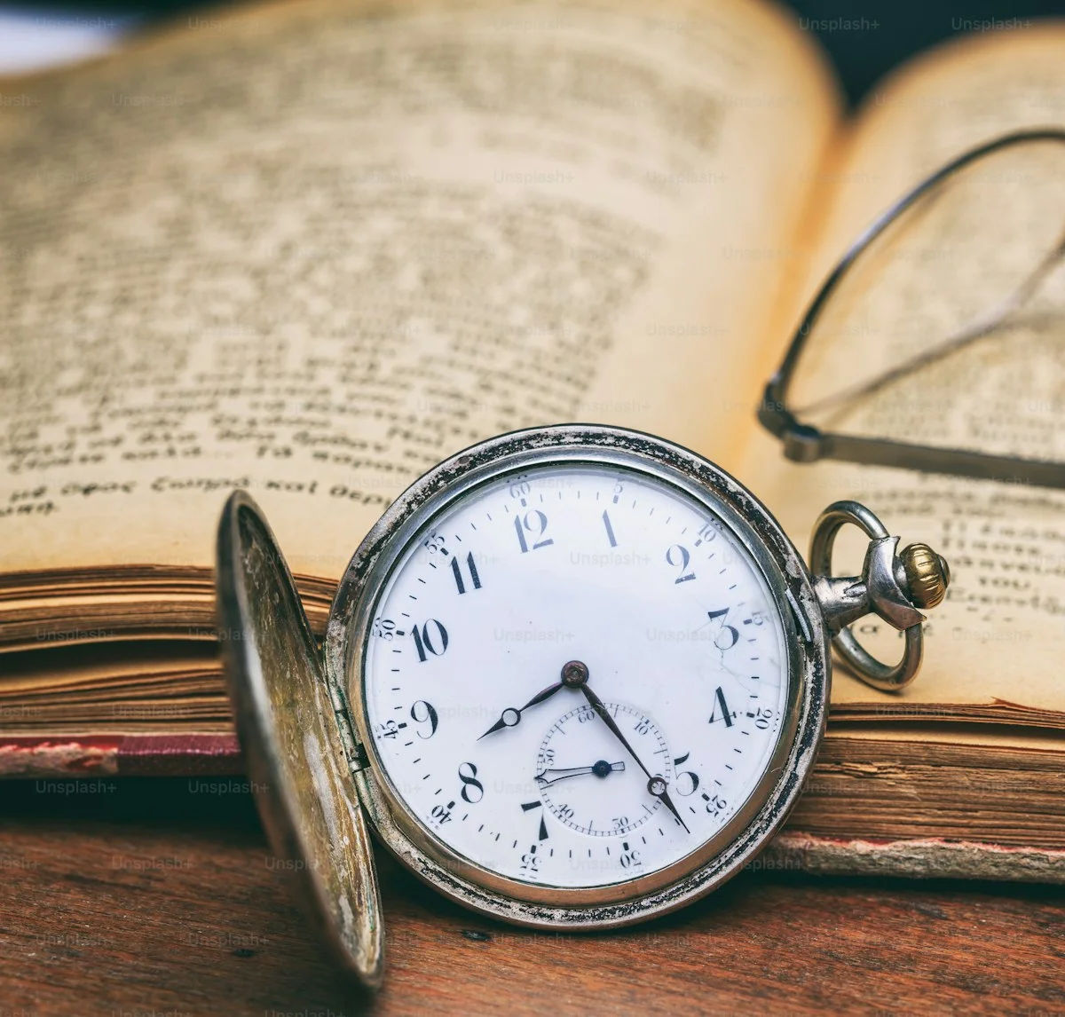 A brass pocket watch on worn leather, open to a quiet morning hour, the hands pointing toward what comes next